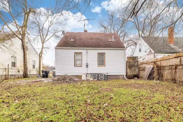 rear view of house featuring a lawn