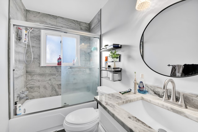 full bathroom featuring shower / bath combination with glass door, vanity, and toilet