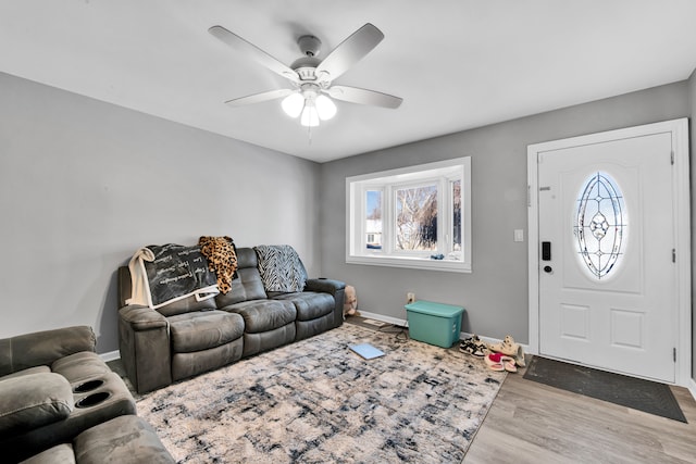 living room with ceiling fan and light hardwood / wood-style flooring