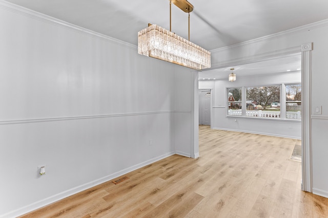 unfurnished dining area featuring a chandelier, light hardwood / wood-style flooring, and ornamental molding