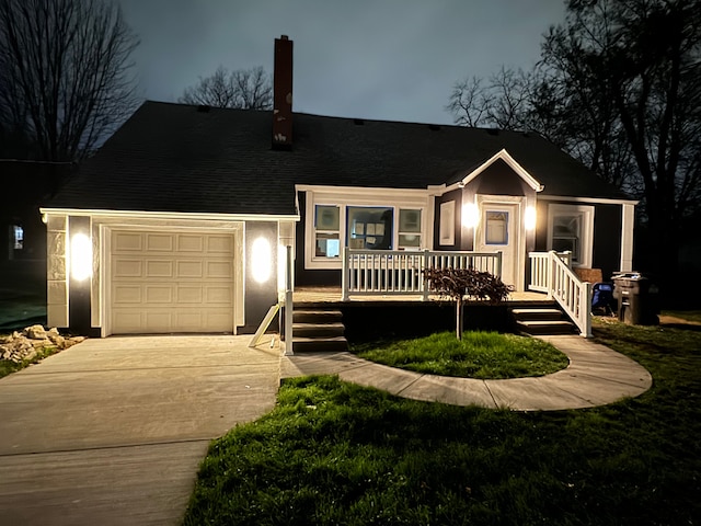 view of front of house featuring a porch and a garage