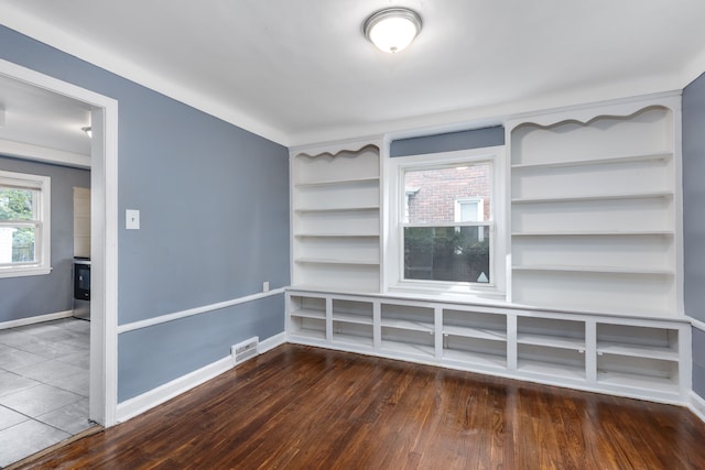 unfurnished room with dark hardwood / wood-style flooring