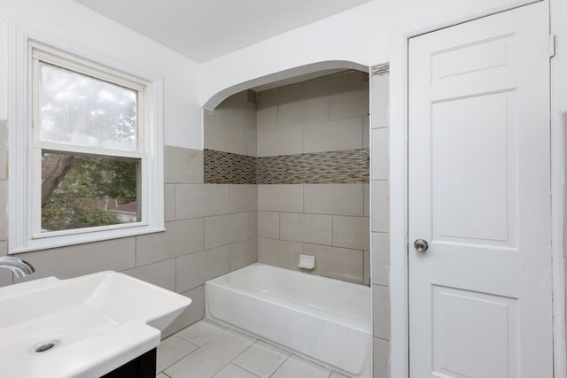 bathroom featuring tile patterned floors, vanity, a healthy amount of sunlight, and tile walls