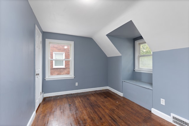 bonus room with dark hardwood / wood-style floors and lofted ceiling