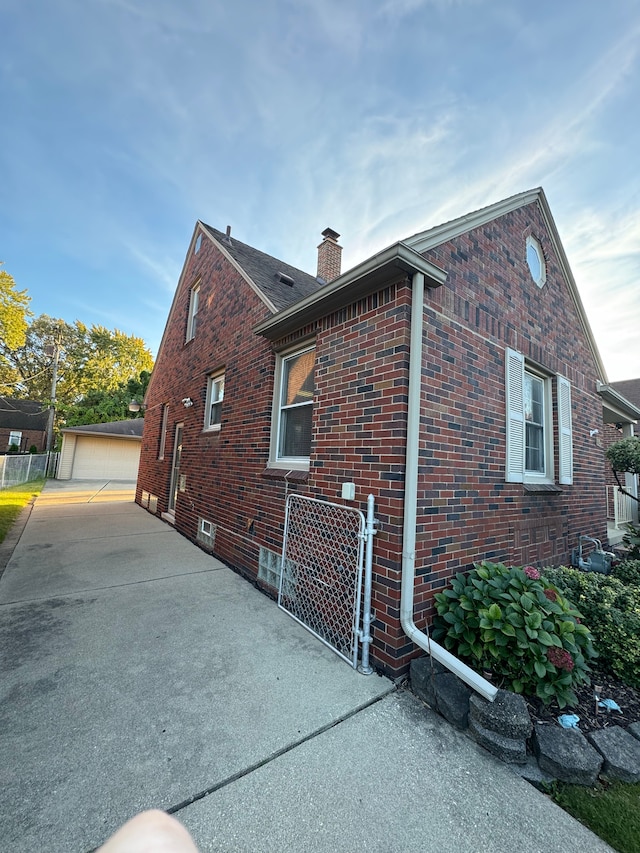 view of side of property featuring an outbuilding and a garage