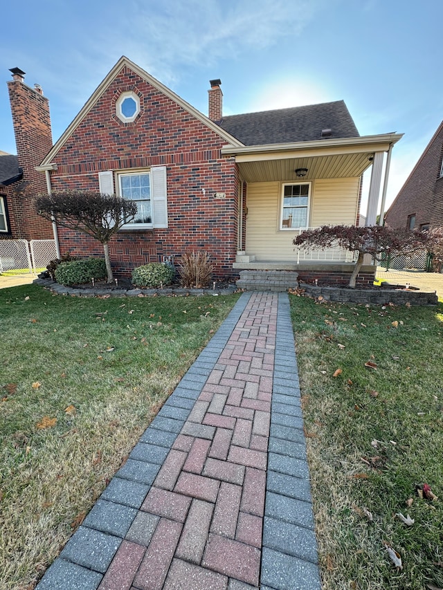 view of front of house featuring a front lawn and covered porch