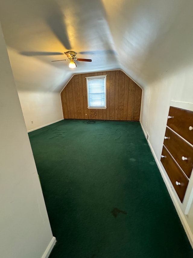 bonus room featuring dark carpet and lofted ceiling