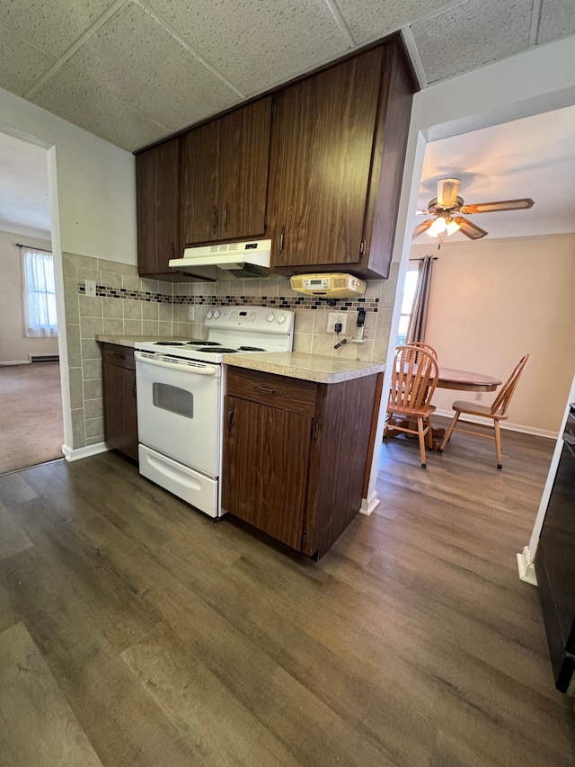 kitchen featuring decorative backsplash, a paneled ceiling, white range with electric stovetop, and dark wood-type flooring