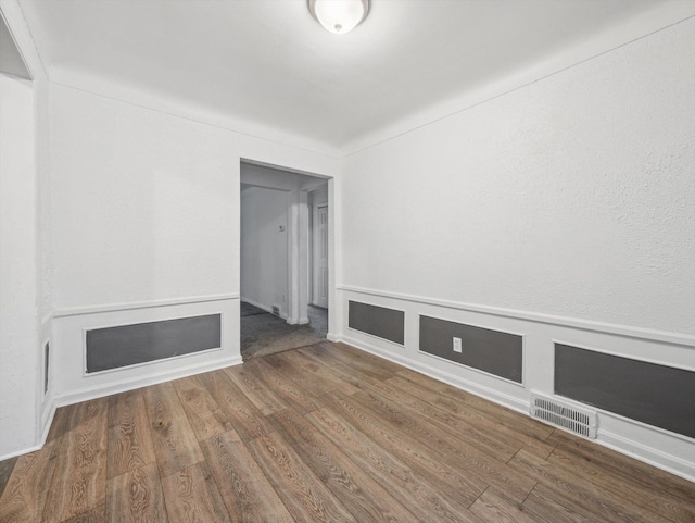 spare room featuring dark hardwood / wood-style floors