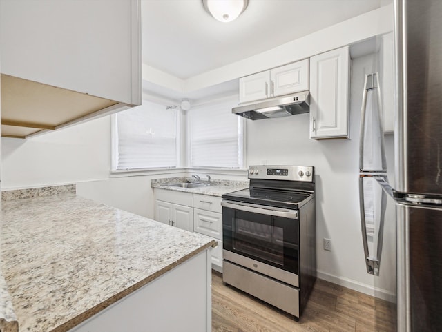 kitchen featuring white cabinetry, stainless steel appliances, light hardwood / wood-style floors, and sink