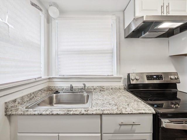 kitchen with sink, electric range, and white cabinets