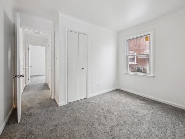 unfurnished bedroom featuring a closet and carpet