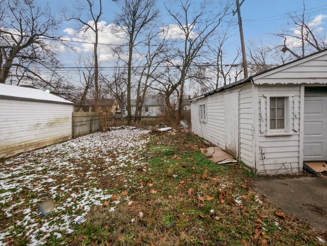 yard covered in snow featuring an outdoor structure