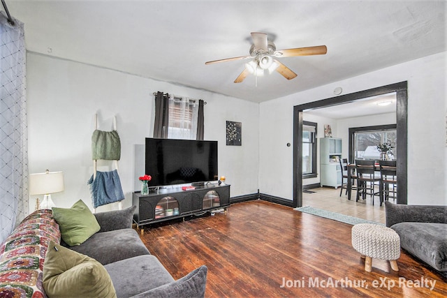 living area with ceiling fan and wood finished floors