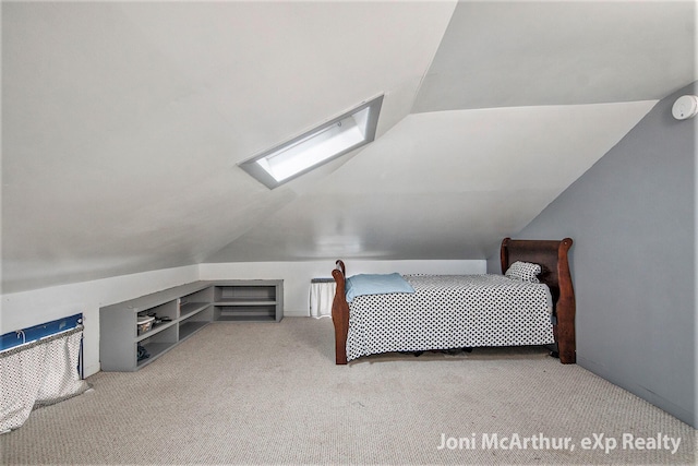 carpeted bedroom with lofted ceiling with skylight