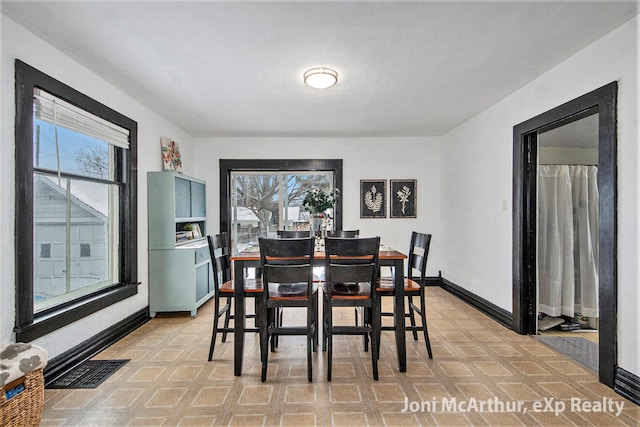 dining room featuring baseboards and visible vents