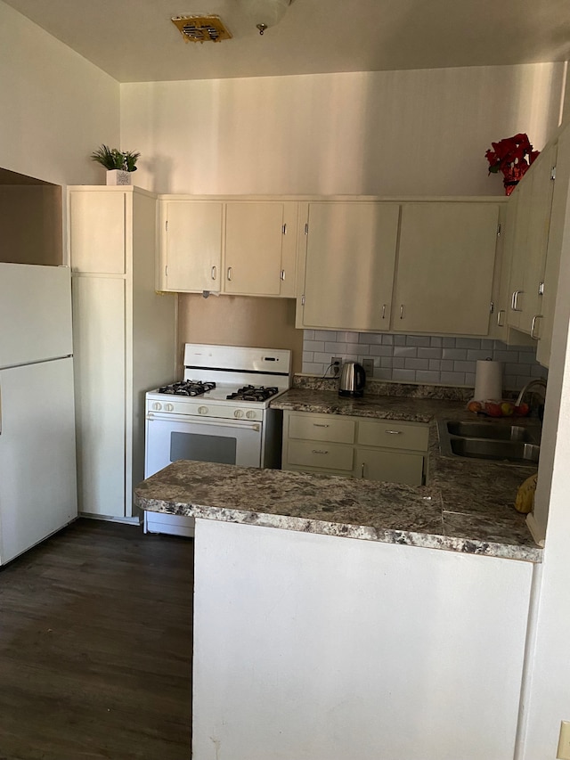 kitchen featuring white appliances, dark hardwood / wood-style floors, backsplash, and sink