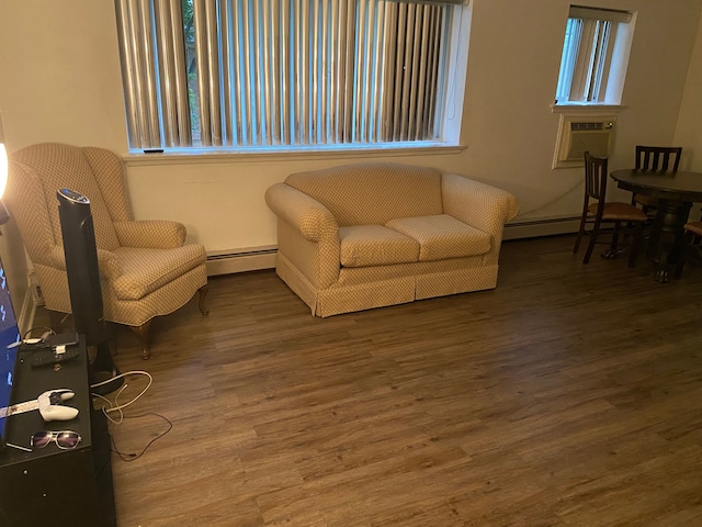 living room with cooling unit, wood-type flooring, and a baseboard radiator