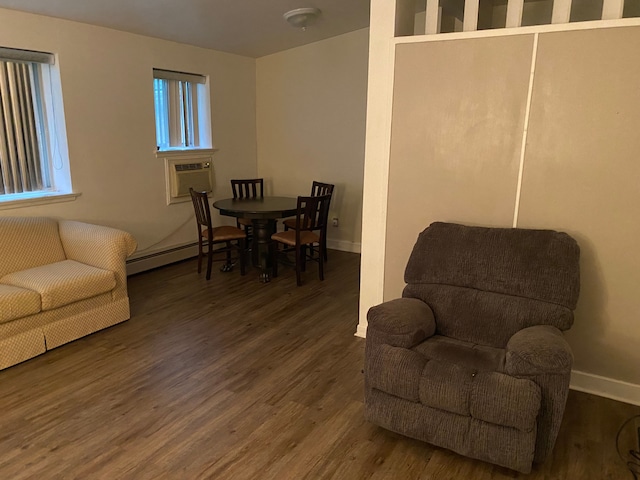 interior space with dark hardwood / wood-style flooring, baseboard heating, and cooling unit