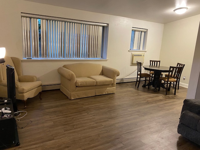 living room with baseboard heating and dark wood-type flooring