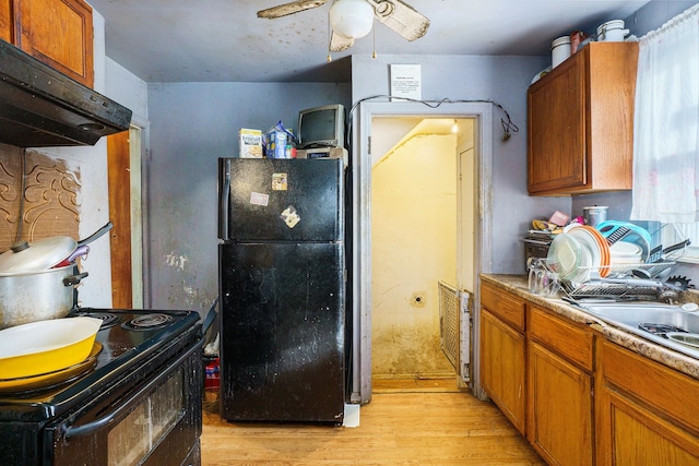 kitchen featuring light wood-type flooring, ceiling fan, and black appliances