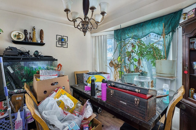 dining space with hardwood / wood-style flooring and a notable chandelier