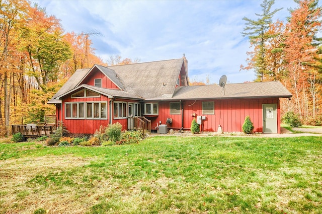 back of property featuring a yard, central AC, a wooden deck, and a sunroom