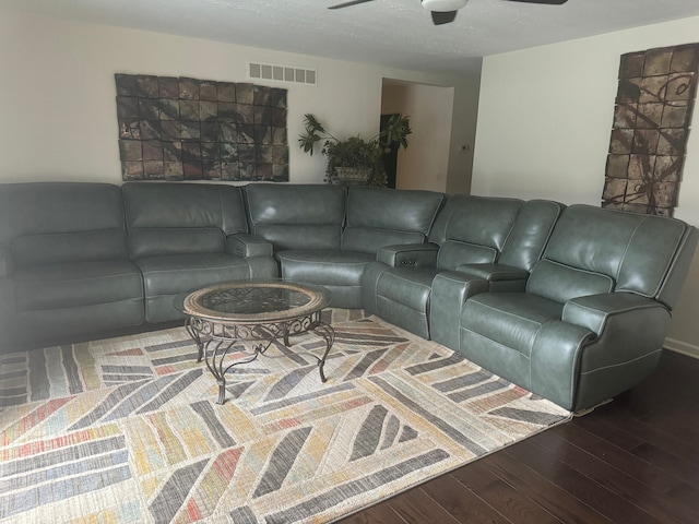 living room with wood-type flooring and ceiling fan