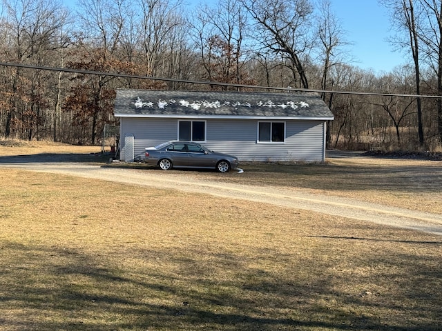 view of outdoor structure featuring a lawn