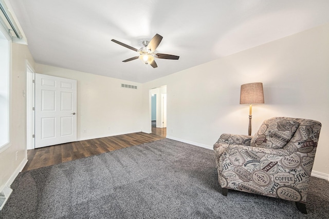 unfurnished room with ceiling fan and dark wood-type flooring