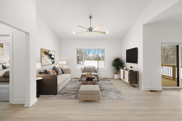 living room with ceiling fan and light hardwood / wood-style floors