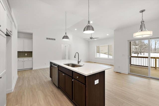 kitchen with dishwasher, sink, decorative backsplash, ceiling fan, and decorative light fixtures