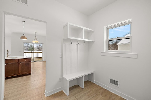 mudroom featuring light hardwood / wood-style flooring and sink