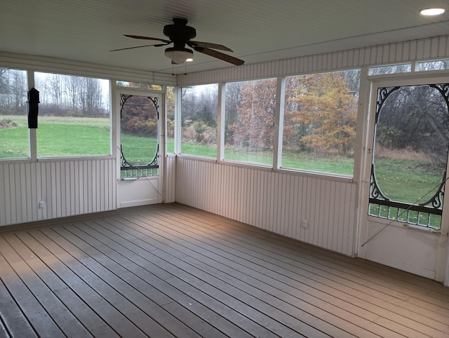 unfurnished sunroom with ceiling fan and a healthy amount of sunlight