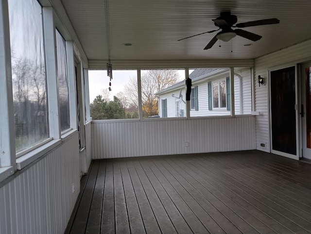 unfurnished sunroom with plenty of natural light and ceiling fan