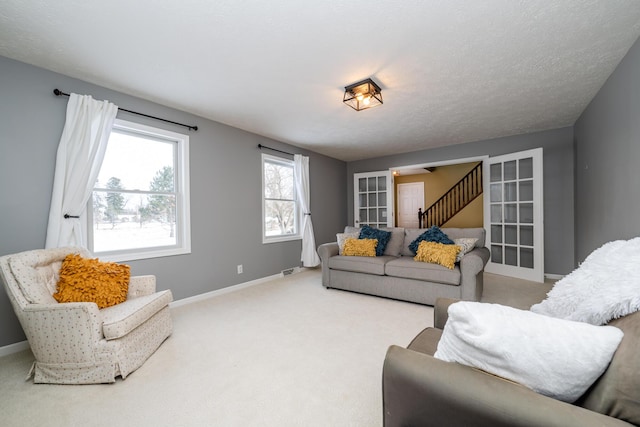 carpeted living room with french doors