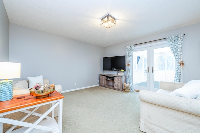 living room featuring french doors, carpet, and a textured ceiling