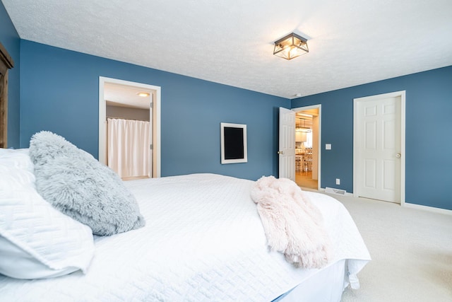 bedroom with a textured ceiling and carpet floors