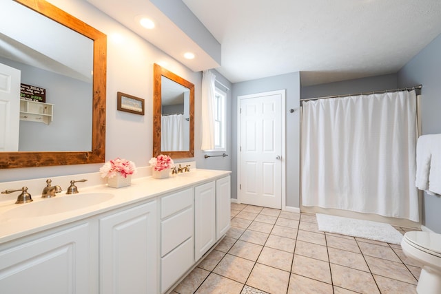 full bathroom with tile patterned floors, vanity, shower / tub combo, and toilet