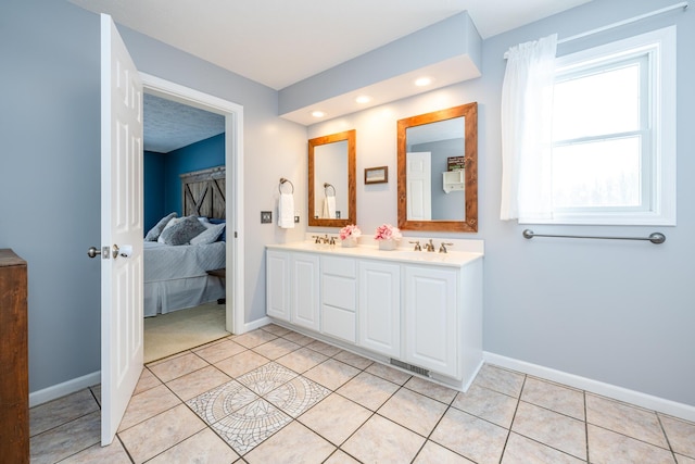 bathroom with tile patterned floors and vanity