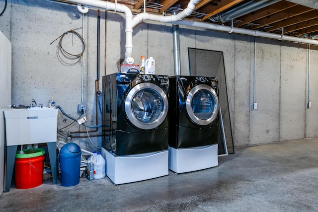 clothes washing area featuring separate washer and dryer