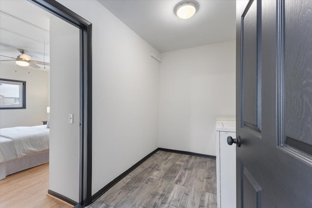 walk in closet with hardwood / wood-style flooring and ceiling fan