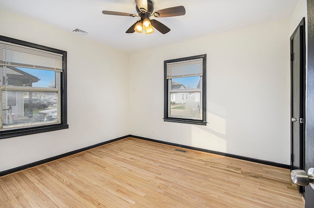 unfurnished room with ceiling fan and light wood-type flooring