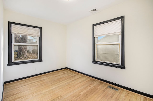 unfurnished room featuring light hardwood / wood-style flooring