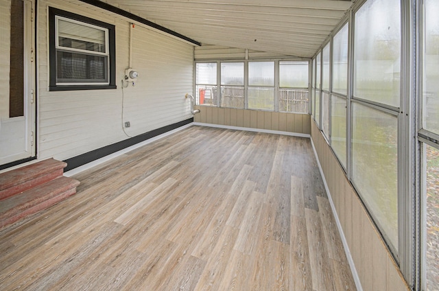 unfurnished sunroom with lofted ceiling and wood ceiling