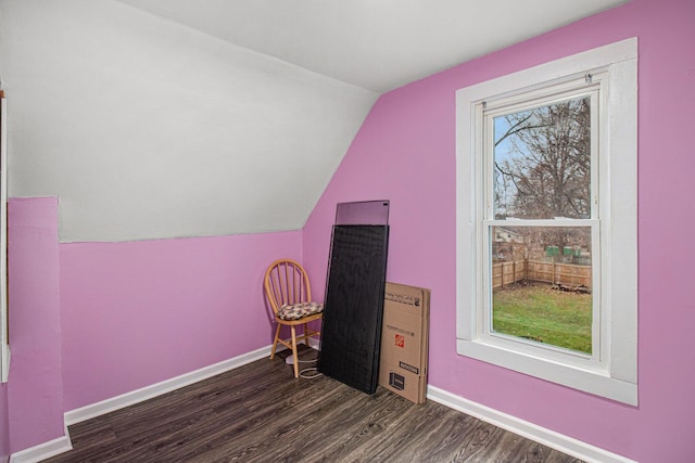 bonus room with plenty of natural light, dark wood-type flooring, and vaulted ceiling