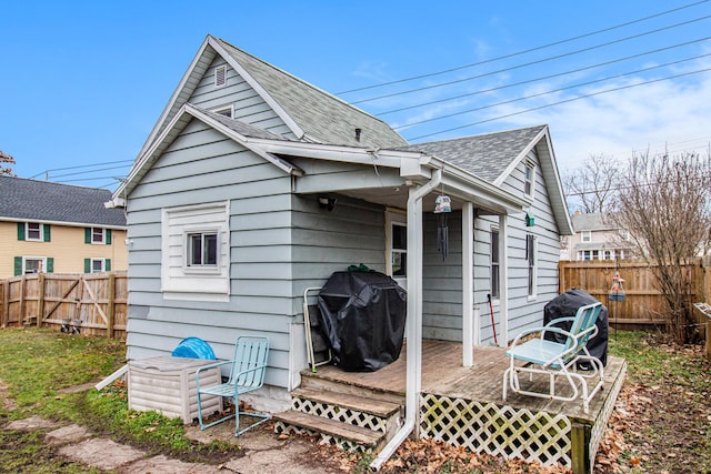 back of house featuring a wooden deck