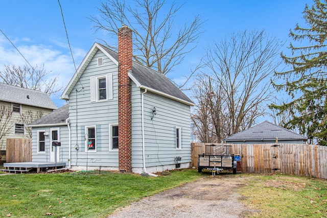 rear view of property with a yard