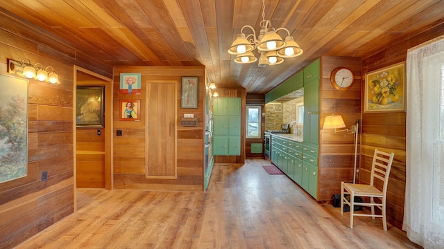 interior space with light wood-type flooring, wood ceiling, wooden walls, and a chandelier