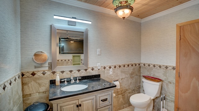 bathroom featuring wood ceiling, vanity, crown molding, tile walls, and toilet